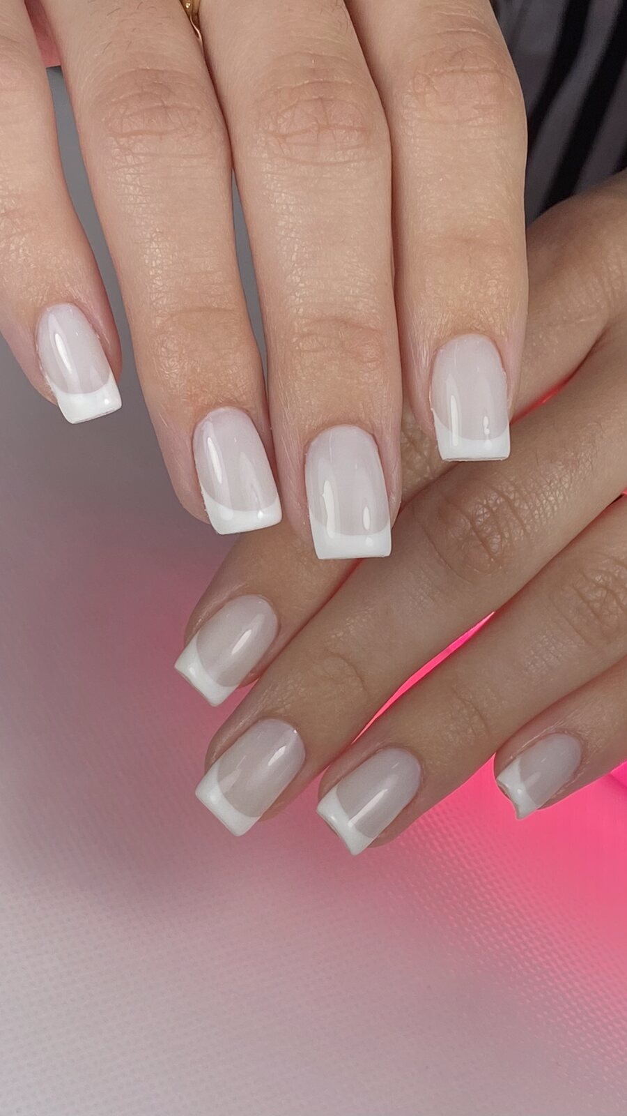 Square French manicure with white tips over a natural base, done at Barbie Studio Miami
